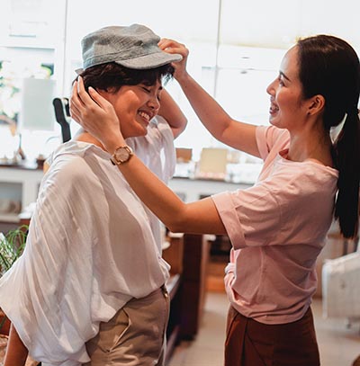 Woman Trying On Hat